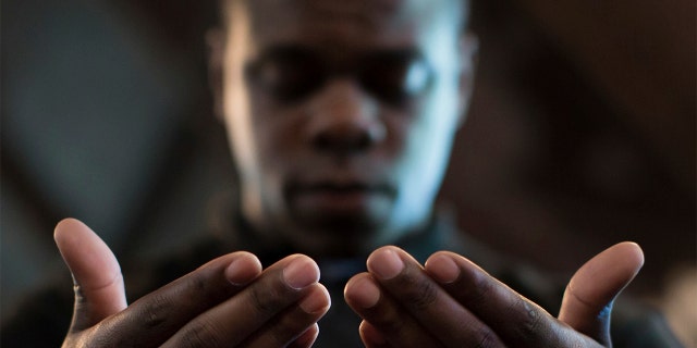 FILE - In this Monday, July 11, 2016 file photo, Paul Bronson prays during a Black Lives Matter prayer vigil at First Baptist Church, a predominantly African-American congregation, in Macon, Ga.  (AP Photo/Branden Camp)