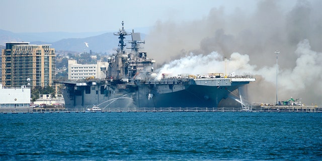 SAN DIEGO , CA - JULY 12: Port of San Diego Harbor Police Department boats combat a fire aboard the amphibious assault ship USS Bonhomme Richard (LHD 6) at Naval Base San Diego, July 12, 2020.  (Photo by Lt. John J. Mike/U.S. Navy via Getty Images)