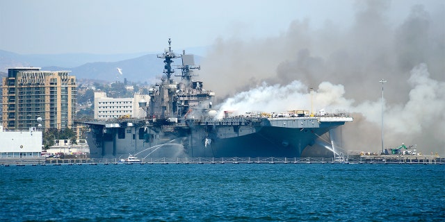 SAN DIEGO , CA - JULY 12: Port of San Diego Harbor Police Department boats combat a fire aboard the amphibious assault ship USS Bonhomme Richard (LHD 6) at Naval Base San Diego, July 12, 2020. (Photo by Lt. John J. Mike/U.S. Navy via Getty Images)