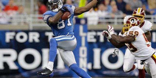 FILE - In this October 26, 2008 file photo, Detroit Lions wide receiver Calvin Johnson catches the Washington Redskins in the fourth quarter of an NFL football game in Detroit.  Johnson was named to the Professional Football Hall of Fame in his first year of eligibility on Saturday, February 6, 2021 (AP Photo / Paul Sancya, on file)