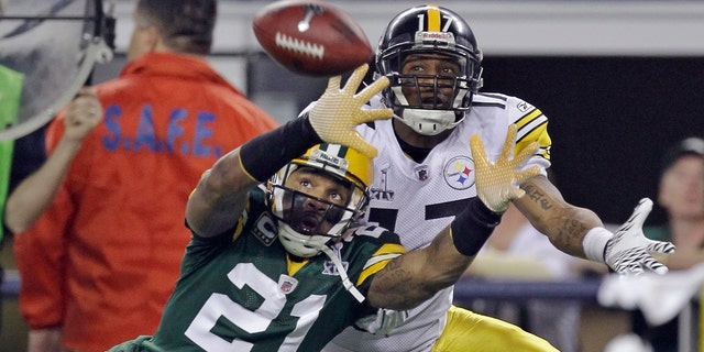 FILE - In this February 6, 2011, file photo, Charles Woodson (21) of the Green Bay Packers defends himself on a pass intended for Mike Wallace of the Pittsburgh Steelers during the first half of the NFL Super Bowl XLV football game in Arlington , Texas, This Sunday Feb.6, 2011, file photo.  (AP Photo / Dave Martin, file)