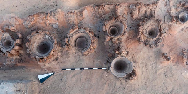 This photo provided by the Egyptian Antiquities Ministry shows pottery basins used to heat up a mixture of grains and water to produce beer, archaeologists say.