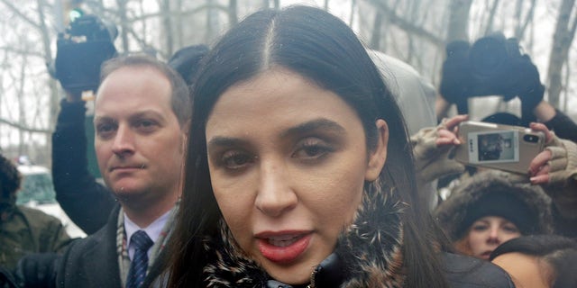 FILE - In this Feb. 12, 2019 file photo, Emma Coronel Aispuro, center, wife of Joaquin "El Chapo" Guzman, leaves federal court in New York. The wife of Mexican drug kingpin and escape artist Joaquin "El Chapo" Guzman has been arrested on international drug trafficking charges at an airport in Virginia. (AP Photo/Seth Wenig)