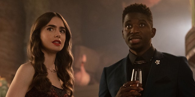 Lily Collins, left, and Samuel Arnold are seen in an episode of "Emily in Paris." (Netflix) 