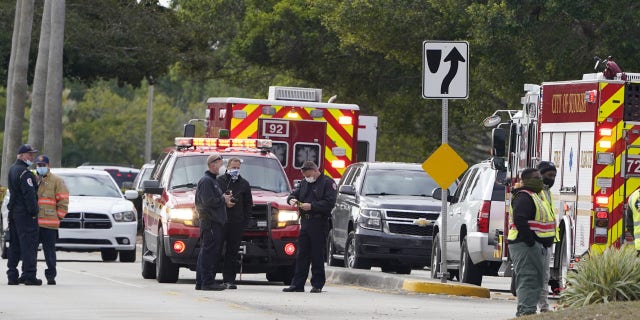 Law enforcement officers block an area where a shooting wounded several FBI while serving an arrest warrant, Tuesday, Feb. 2, 2021, in Sunrise, Fla. (AP Photo/Marta Lavandier)