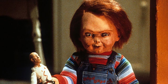 Chucky with a doll in a scene from the movie 'Child's Play', 1988 (Photo by United Artists / Getty Images)