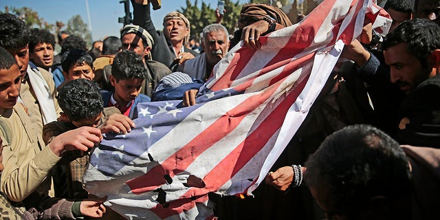 Houthi supporters burn an American flag during a protest on January 18, 2021 outside the U.S. Embassy in Sanaa against the United States over its decision to designate the Houthi rebel movement a foreign terrorist organization. 