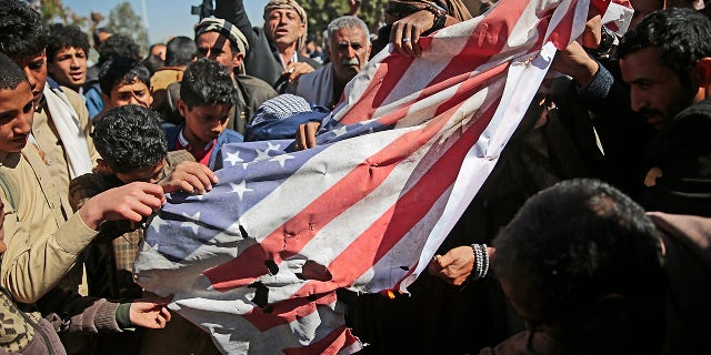 Houthi supporters burn a U.S. flag during a protest Jan. 18, 2021, in front of the U.S. embassy in Sanaa against the United States over its decision to designate the Houthi rebels movement as a foreign terrorist organization.