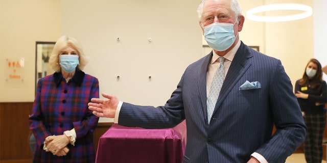 Britain's Prince Charles, Prince of Wales ([R) and Britain's Camilla, Duchess of Cornwall take part in a plaque unveiling ceremony during a visit to the Queen Elizabeth Hospital in Birmingham, northern England on February 17, 2021.