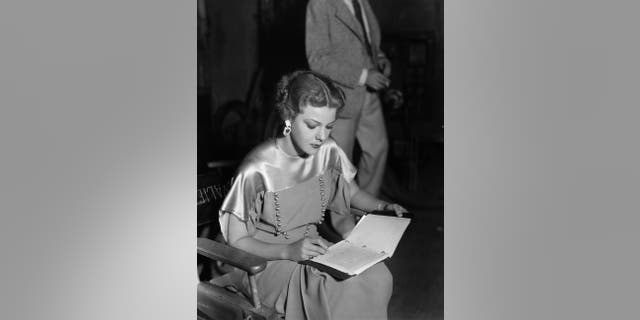 Actress Elissa Landi concentrates on a bit of writing between takes of the Paramount film 'The Great Flirtation', directed by Ralph Murphy.