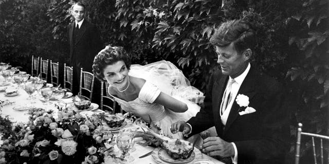 Sen. John Kennedy and Jacqueline Lee Bouvier (wearing Ann Lowe) enjoy their wedding reception, 1953.