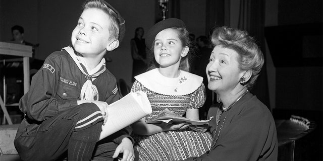 Bobby Driscoll (left) with Hedda Hopper (right) and Luana Patten (center), circa 1947.