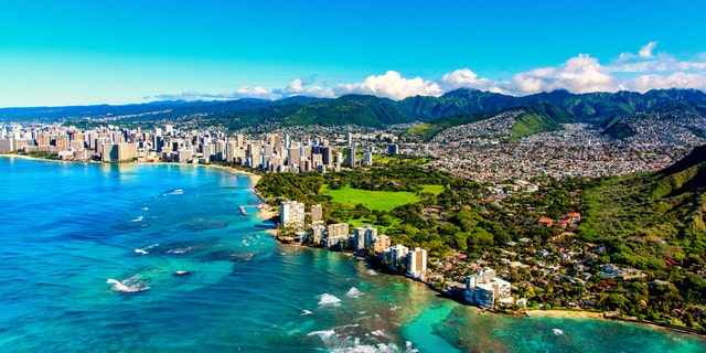 The coastline of Honolulu, Hawaii including the base of Diamond Head crater.
