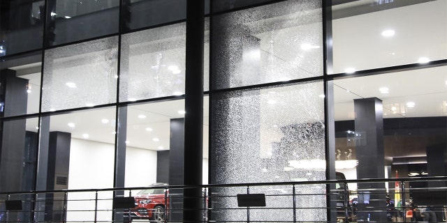 A damage is seen on the windows of an auto showroom at the Gulan Street after two rockets landed inside the Erbil International Airport. (Photo by Yunus Keles/Anadolu Agency via Getty Images)
