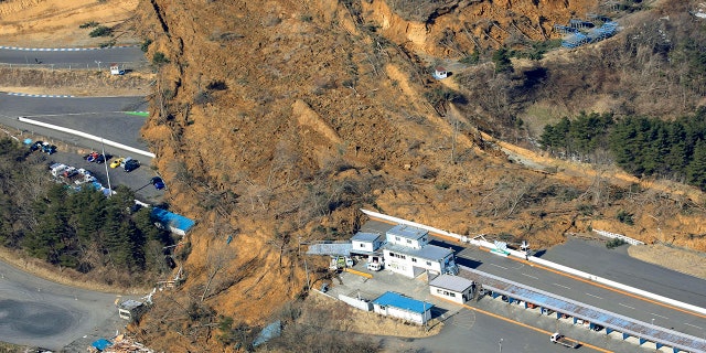 A landslide caused by a strong earthquake covers a circuit course in Nihonmatsu city, Fukushima prefecture, northeastern Japan, Sunday, Feb. 14, 2021. (Associated Press)