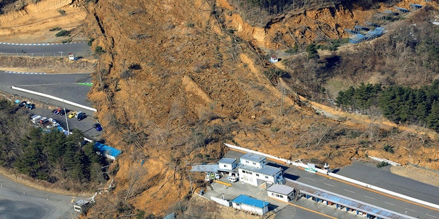 A landslide caused by a strong earthquake covers a circuit course in Nihonmatsu city, Fukushima prefecture, northeastern Japan, Sunday, Feb. 14, 2021. (Associated Press)
