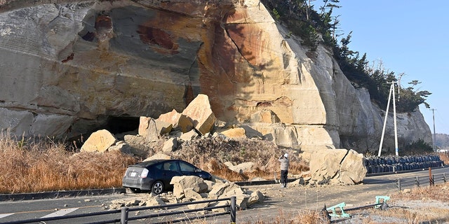 Collapsed rocks block a road after a strong earthquake hit Soma city, Fukushima prefecture, northeastern Japan, Sunday, Feb. 14, 2021. (Associated Press)