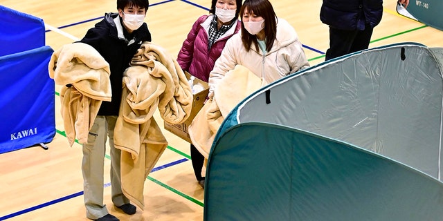 Evacuees shelter at a gym as an earthquake hit the area, in Soma, Fukushima prefecture, northeastern Japan, Sunday, Feb. 14, 2021. (Associated Press)
