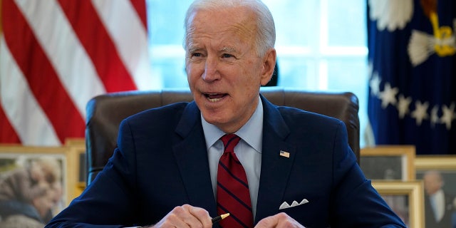 President Biden signs a series of executive orders on health care in the Oval Office of the White House, Thursday, Jan. 28, 2021, in Washington. 