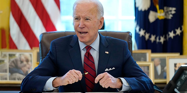 President Biden signs a series of executive orders on health care in the Oval Office of the White House, Thursday, Jan. 28, 2021. (AP Photo/Evan Vucci)