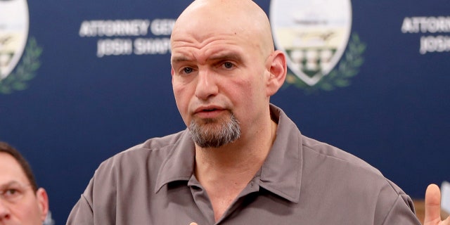 Pennsylvania Lieutenant Governor John Fetterman speaks as he stands beside state Attorney General Josh Shapiro during a news conference about legal action in the dispute between health insurance providers UPMC and Highmark, Thursday, Feb. 7, 2019, in Pittsburgh. (AP Photo/Keith Srakocic)