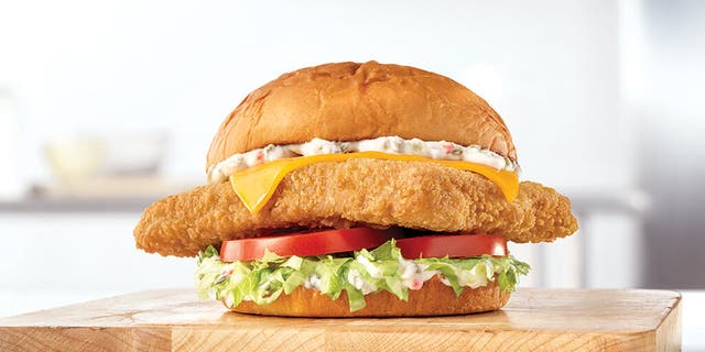 Arby’s King's Hawaiian Fish Deluxe sandwich is beefed up with iceberg lettuce, tomatoes, cheese and tartar sauce on a King Hawaiian bun.