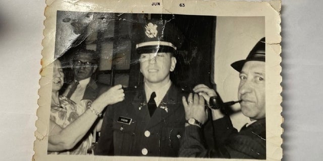 Seymour Kagan's mother and father pin his second liutentant bars on his uniform following his graduation from Rutgers University's ROTC program in 1963. His uncle, in the background, looks on. (Courtesy Seymour Kagan)