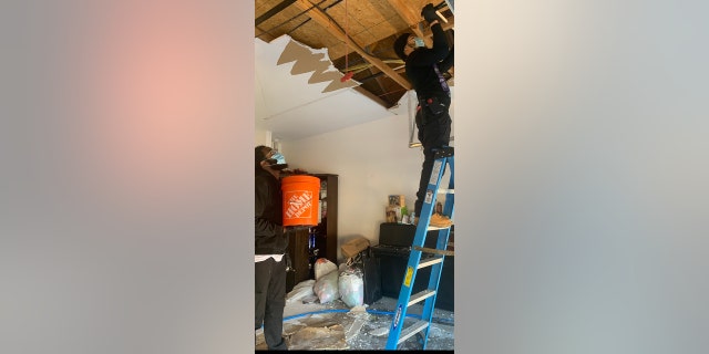 Andrew Mitchell and Isaiah Pinnock helping storm victims in Houston, Texas.