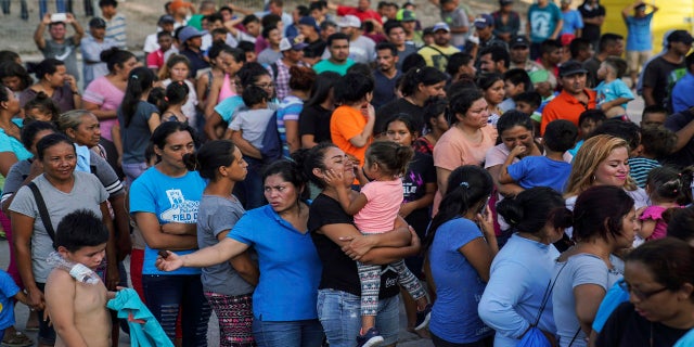 In this August 2019 photo, migrants -- many of whom were returned to Mexico under the Trump administration's