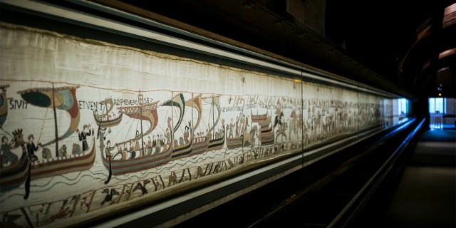 This file photo taken, Sept. 18, 2019 shows a large part of the 11th century Bayeux tapestry chronicling the Norman conquest of England, in Bayeux, Normandy, France. (AP Photo/Kamil Zihnioglu, File)