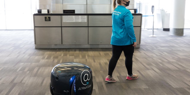 The gita robots use visual sensors to follow an AtYourGate employee through the airport to the person who ordered the food.