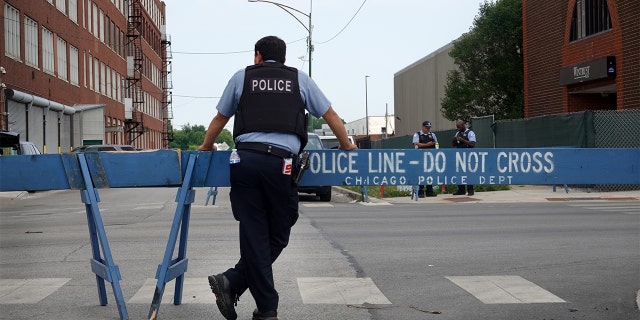 CHICAGO, ILLINOIS - AUGUST 15: Police stand guard as pro and anti-police demonstrators are expected to gather outside of the Homan Square police station on August 15, 2020 in Chicago, Illinois. The demonstration was one of several in the city today, either in support of or in opposition to police. (Photo by Scott Olson/Getty Images)