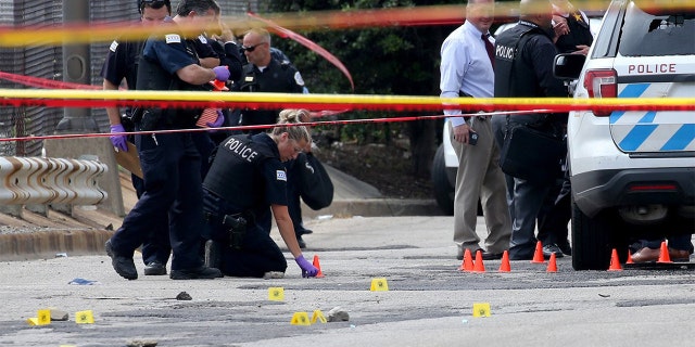 Chicago police officers investigate an officer-involved shooting outside the department's 25th district station on July 30, 2020. According to police, a prisoner was shot and and two officers were wounded. (Antonio Perez/Chicago Tribune/Tribune News Service via Getty Images)