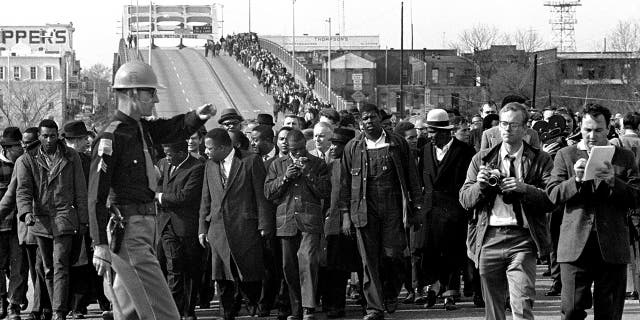 In this file photo dated March 10, 1965, demonstrators, including Dr.  Martin Luther King Jr., during a suffrage march over an Alabama bridge on the Selma, Ala, city limits.  King's participation in the 54-mile march from Selma, Ala., To the state capital, Montgomery, raised awareness of the problems blacks faced when registering to vote.  (AP photo / file)