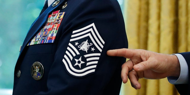 FILE - In this May 15, 2020, file photo, Chief Master Sgt. Roger Towberman displays his insignia during a presentation of the United States Space Force flag in the Oval Office of the White House in Washington. (AP Photo/Alex Brandon, File)