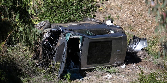 A vehicle lies on its side after a rollover accident involving golfer Tiger Woods along a road in the Rancho Palos Verdes section of Los Angeles on Tuesday, February 23, 2021. Woods sustained a leg injury in the crash. a car and was undergoing surgery.  the authorities and its director said.  (AP Photo / Ringo HW Chiu)