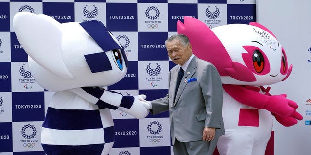 Tokyo Olympic mascot "Miraitowa," on the left, and Paralympic mascot "Someone," right, and Tokyo Olympic Organizing Committee chairman Yoshiro Mori on stage at the first mascot event in Tokyo 2018 (AP)