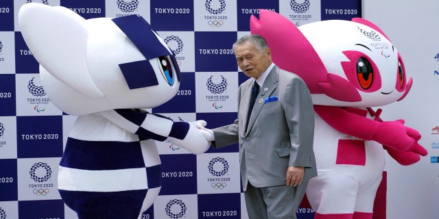 Tokyo Olympic mascot "Miraitowa," on the left, and Paralympic mascot "Someone," right, and Tokyo Olympic Organizing Committee chairman Yoshiro Mori on stage at the first mascot event in Tokyo 2018 (AP)