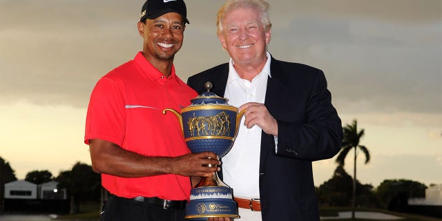 DORAL, FL - MARCH 10: Tiger Woods and Donald Trump pose with the Gene Sarazen Cup after his two-stroke victory during the final round of the World Golf Championships-Cadillac Championship at TPC Blue Monster at Doral on March 10, 2013 in Doral, Florida. (Photo by Stan Badz/PGA TOUR)