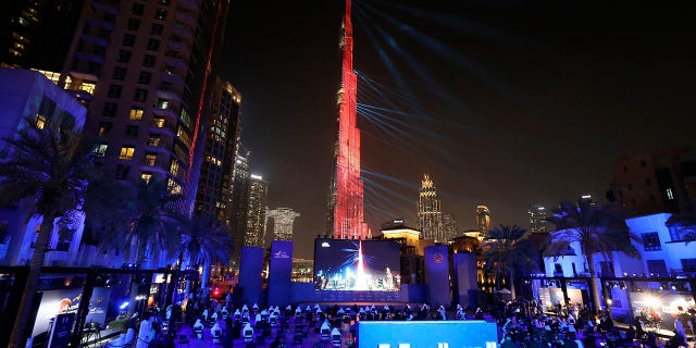 The world tallest tower, Burj Khalifa is lit up with a laser show to celebrate the Hope Probe entering Mars orbit as a part of the Emirates Mars mission, in Dubai, United Arab Emirates, Tuesday, Feb. 9, 2021. The spacecraft from the UAE swung into orbit around Mars in a triumph for the Arab world’s first interplanetary mission. It is the first of three robotic explorers arriving at the red planet over the next week and a half. (AP Photo/Kamran Jebreili)