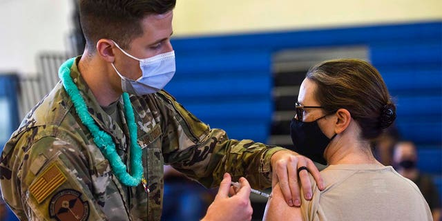 In this Feb. 9, 2021 photo provided by the Department of Defense, Hickam 15th Medical Group host the first COVID-19 mass vaccination on Joint Base Pearl Harbor-Hickam. (U.S. Air Force Tech. Sgt. Anthony Nelson Jr./Department of Defense via AP)