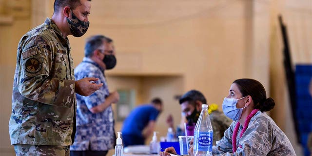 In this February 9, 2021 photo provided by the Department of Defense, Hickam 15th Medical Group hosts the first mass vaccination against COVID-19 at the Pearl Harbor-Hickam Joint Base.  (US Air Force Tech. Sgt. Anthony Nelson Jr./Department of Defense via AP)