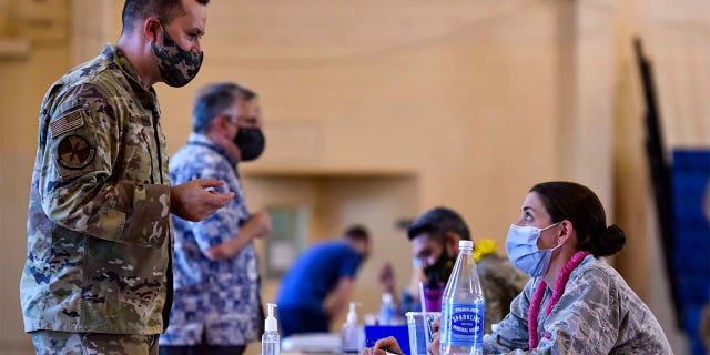 In this Feb. 9, 2021 photo provided by the Department of Defense, Hickam 15th Medical Group host the first COVID-19 mass vaccination on Joint Base Pearl Harbor-Hickam. (U.S. Air Force Tech. Sgt. Anthony Nelson Jr./Department of Defense via AP)