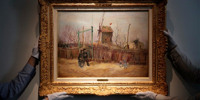 Sotheby's staff are exhibiting “Scene de rue à Montmartre”, a painting by Dutch master Vincent van Gogh at the Sotheby's auction house in Paris, on Thursday, February 25, 2021. (AP Photo / Christophe Ena)