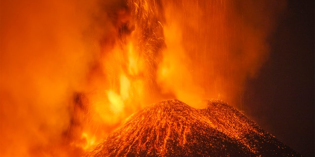 Lava and smoke are belched out from a crater as seen from the north-east side of the Mt Etna volcano near Milo, Sicily, Wednesday night, Feb. 24, 2021.  (AP Photo/Salvatore Allegra)