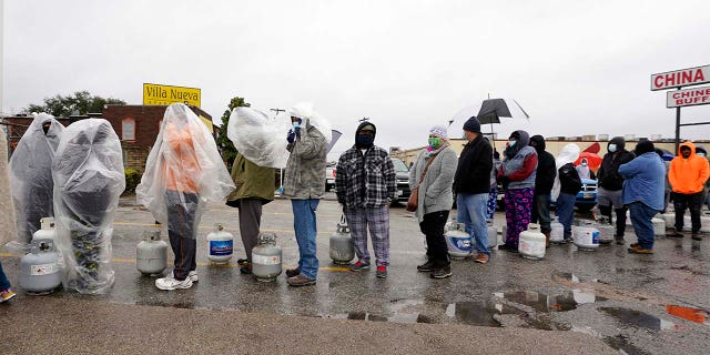 People line up to fill propane tanks Wednesday, February 17, 2021, in Houston. 