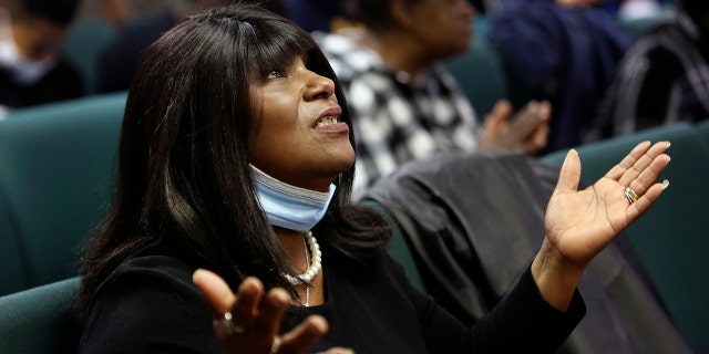 A congregant of the Faith Center Church lifts her hands toward the sky as she worships with others in Bluefield, W.Va., on Saturday, Jan. 24, 2021. (AP Photo/Jessie Wardarski)