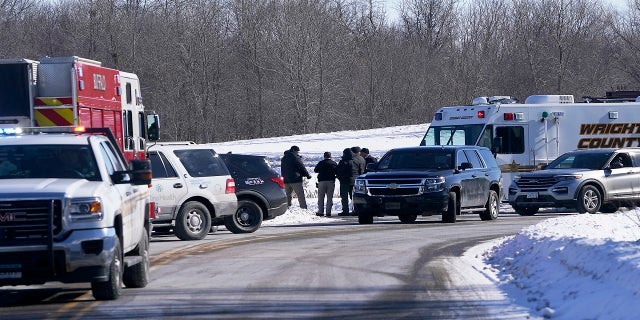 Law enforcement personnel and first responders gather outside of the Allina Health clinic Tuesday. (AP/Star Tribune)