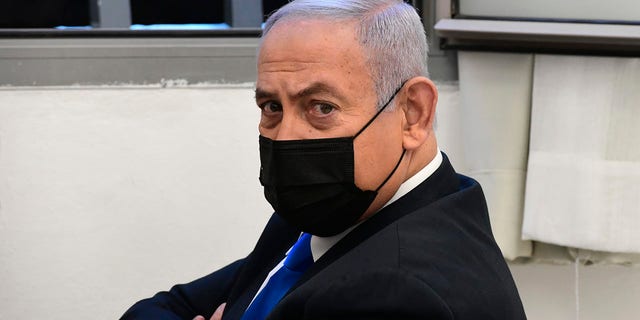 Israeli Prime Minister Benjamin Netanyahu looks on prior to a hearing at the district court in Jerusalem, Monday, Feb. 8, 2021. (AP Photo/Reuven Castro, Pool)