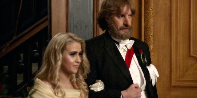 This image released by Amazon Studios shows Maria Bakalova, left, and Sacha Baron Cohen in a scene from "Borat Subsequent Moviefilm." The film was nominated for a Golden Globe for best musical/comedy.